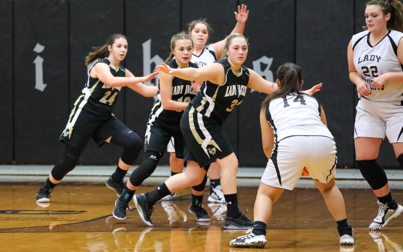 The trio of Annessca Guyette, Lila Roberts and Kaylee Leath- erwood clog the lane against Robbinsville.