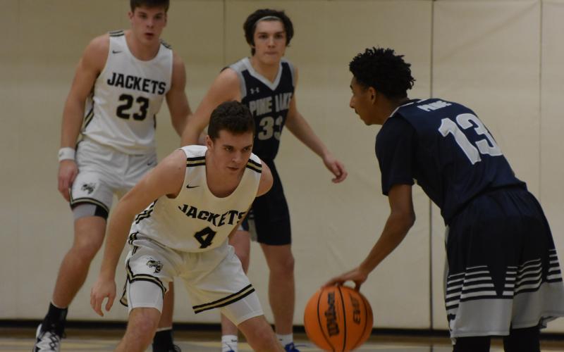 (Travis Dockery - Clay County Progress) Junior Hayden McClure has his eyes locked onto the ball just before making the steal against Pine Lake.