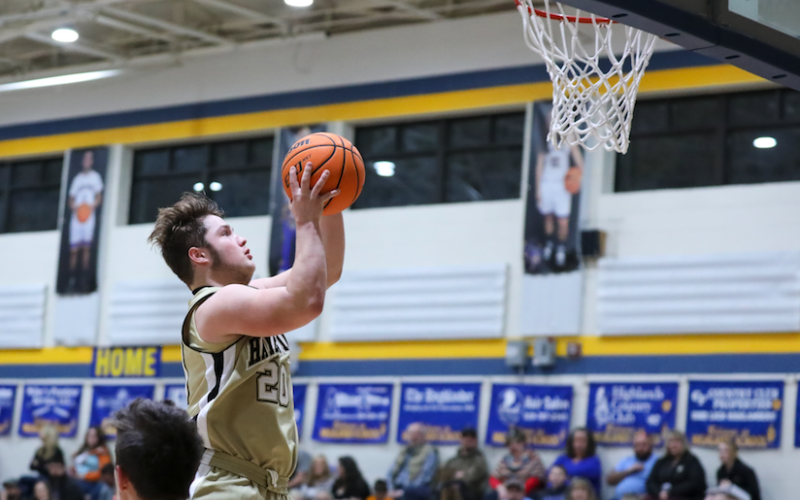 (Kelli Graves • Clay County Progress) Junior Blake McClure soars to the basket for 2 of his 8 points Monday.