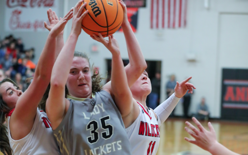 (Kelli Graves • Clay County Progress) Breanna Foster finds herself in a battle for the ball under- neath the basket.