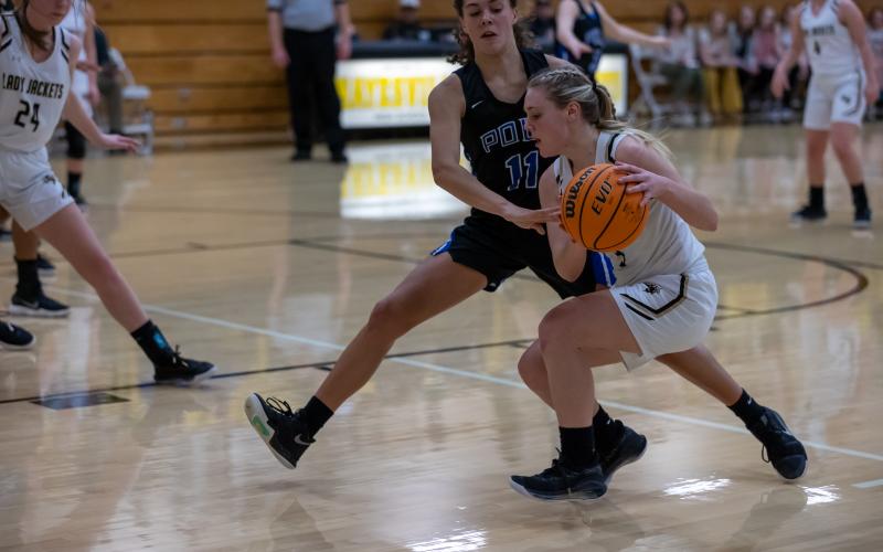 (Kelli Graves • Clay County Progress) Lizzy Brusini protects the ball as she drives the base line for 2 of her team-high 17 points to open the playoffs.