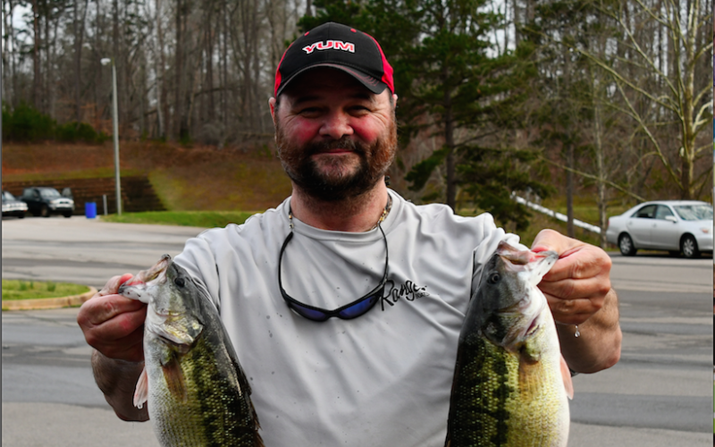 Dean Tucker shows off the 4.09 pound spotted bass that earned him the big fish.