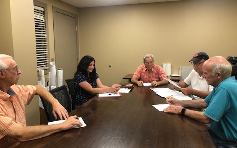 Lorrie Ross • Clay County Progress The Clay County ABC board met in June to approve the 2020-2021 budget, as well as amendments to the current year's budget. Left to right: Board member Carl Patterson, finance officer Olivia Anderson, board chairman Tommy Moore, Hayesville ABC manager Denny Patterson, and board member Buck Shaver.