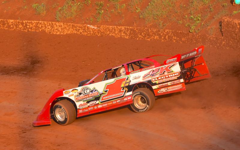 (Travis Dockery • Clay County Progress) Eventual Super Late Model winner Kenny Collins hits the high line during practice laps at Tri County Racetrack.