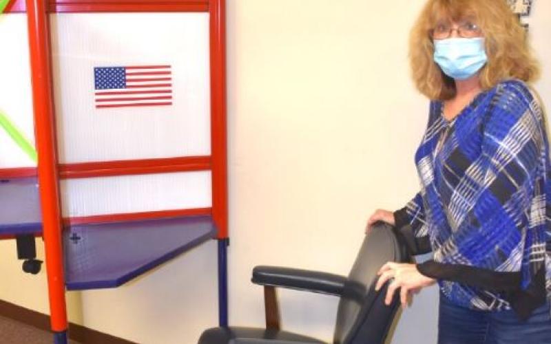 (Travis Dockery • Clay County Progress) Board of Elections Deputy Director, Patty Swanson, prepares a handicap accessible voting booth in preparation for early voting which begins Thursday, Oct. 15. Voters can take advantage of early voting on the square at 54 Church Street.
