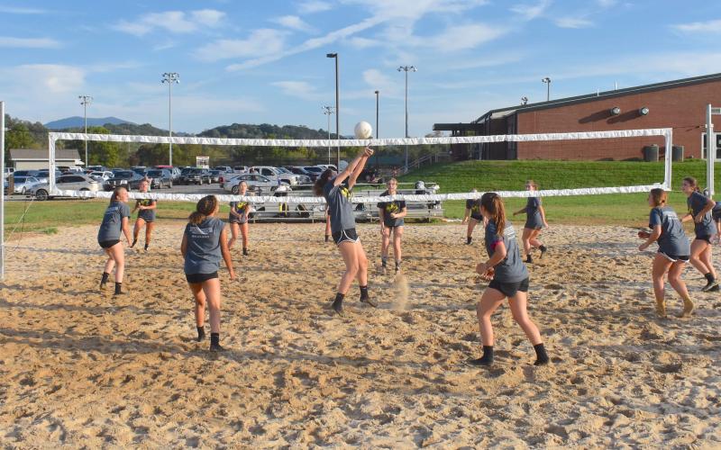 (Travis Dockery • Clay County Progress) The volleyball squads from Hayesville High School swarm the newly-finished outdoor court at the Clay County Recreation Center.