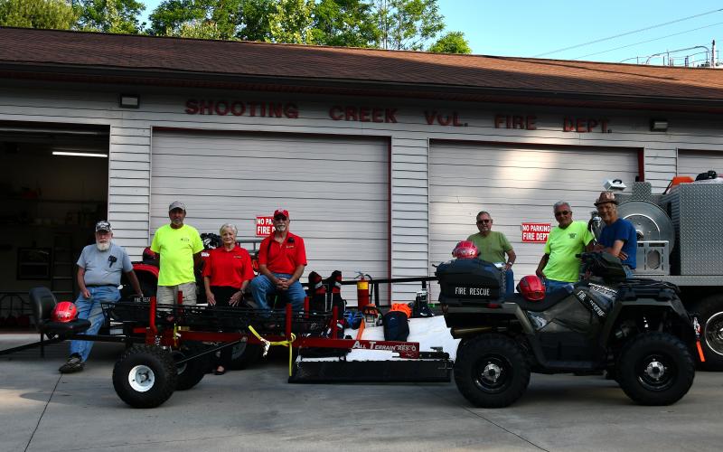 Shooting Creek members, from left, Jon Ashe, Joe Davenport, Lynn Trocchia, Pete Trocchia, Stanley Robinson, Tom Bussolari and Wade Moss admire the new rescue ATV and stokes basket trailer.