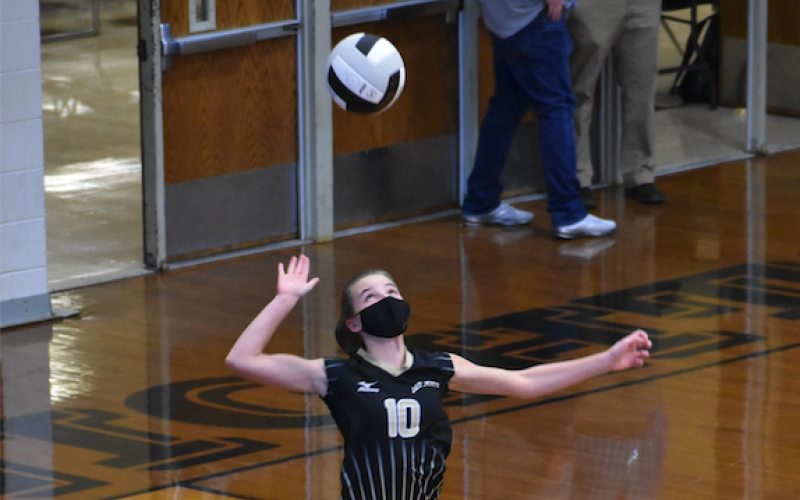 (Kevin Hensley • Graham Star) Ava Shook takes flight for one of her four ace serves against Robbinsville.