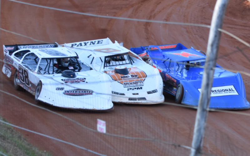 Travis Dockery • Clay County Progress Jamie Oliver, left, David Payne, middle and Shawn Chastain put the maximum amount of sheet metal in a limited space in Saturday afternoon’s Super Late Model main event.