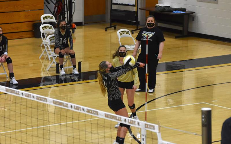 Travis Dockery • Clay County Progress Head coach Tammy Dills and Lady Jacket Madison Crawford look on as Emma Shook executes a no-look hit to keep the volley going.