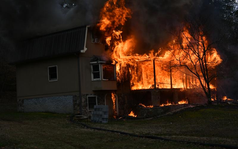 (Photo by Joe Davenport) Upon arrival to the home on Hot House Road, firefighters discover the house is fully involved and not safe to enter.