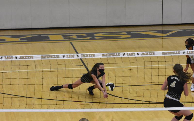 (Travis Dockery • Clay County Progress) Ava Shook hits the floor just in time to get under a potential point for Rosman.