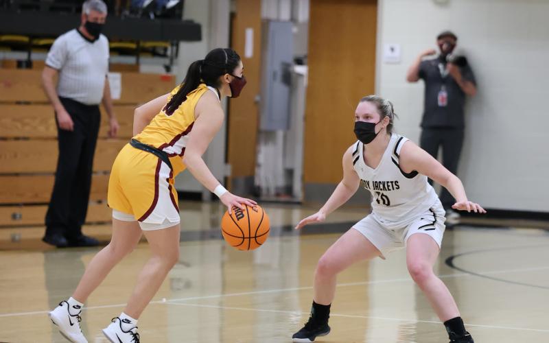 (Kelli Graves • Clay County Progress) Senior Kynnly McClure meets a Lady Brave at half court as Hayesville takes on Cherokee.