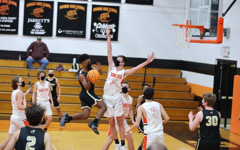 (Kelli Graves • Clay County Progress) Freshman Asher Brown takes flight and dishes a pass to an awaiting teammate under the basket.