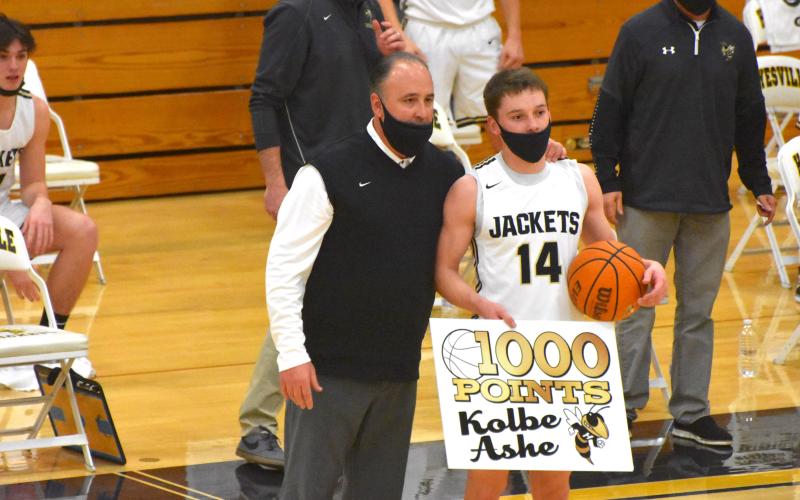 (Travis Dockery • Clay County Progress) Coach Mike Cottrell takes a moment to recognize Kolbe Ashe’s 1000th point accomplisment. Ashe would go on to have a career-high 34 points in the playoff game win.