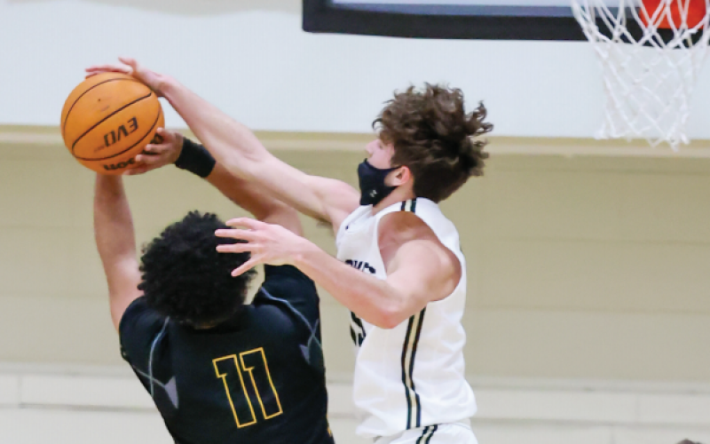 (Kelli Graves • Clay County Progress) Brady Shook takes flight and stops a Bulldog’s shot mid-air during Friday’s rivalry game.