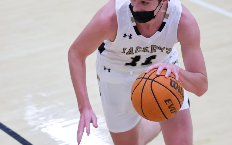 (Kelli Graves • Clay County Progress) Senior Paul White starts a drive from the top of the key