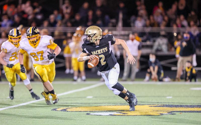 (Kelli Graves • Clay County Progress) Quarterback Logan Caldwell shows off his fancy foot work as he gains yards.