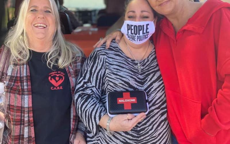 (Regina Cothren • Photo submitted) Stephanie Almeida, of Smoky Mountain Harm Reduction, brought Narcan kits to give free in Clay County on Saturday, March 20. She will be back from 1-2 p.m., Saturday, March 27 at Oak Forest UMC, 990 Oak Forest Road in Hayesville. Almeida (center) stands with People of Clay CARE board member Debbi Tucker, left, and Stacie Ledford from Rock Bottom Recovery and Support, right.