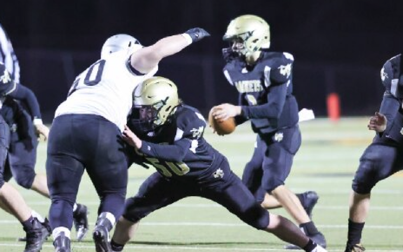 (Kelli Graves • Clay County Progress) Seth McCaslin does his best to create time for quarterback Logan Caldwell.