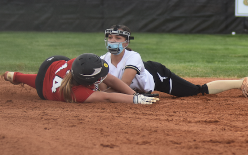 (Travis Dockery • Clay County Progress) Jayden Moore applies the tag to stop a Lady Wildcat from reaching second base.