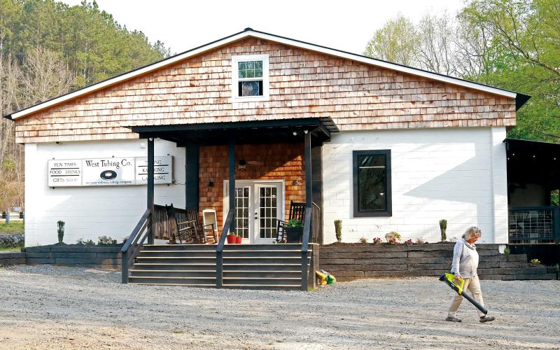 Jared Putnam • Clay County Progress West Tubing Company manager Donna Freisen does maintenance around the property on Tuesday in Warne. The business is located in the building that once housed the Tellico Lace plant.