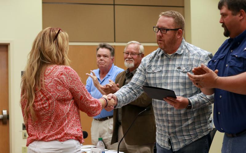 Jared Putnam • Clay County Progress Clay County Commissioners Scotty Penland, Clay Logan, Rob Peck and Randy Nichols look on as Stacie Ledford, president of Rock Bottom Recovery, receives the 2021 Governor’s Volunteer Service Award for Clay County during the board of commissioners meeting on May 6 in Hayesville.