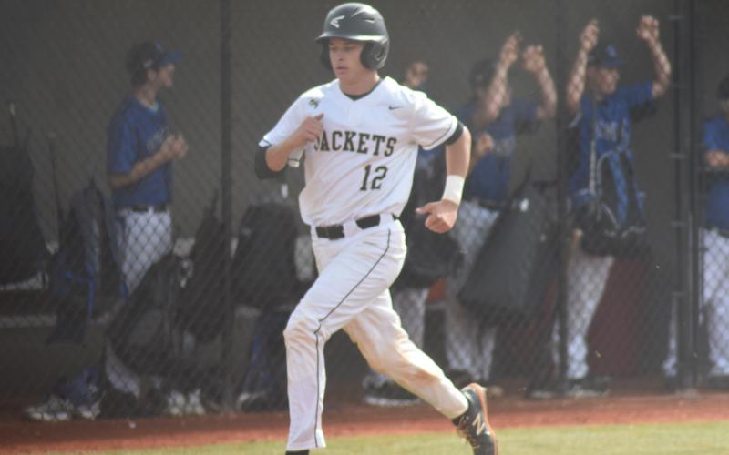 Avery Leatherwood trots into home to score a run for the Jackets.