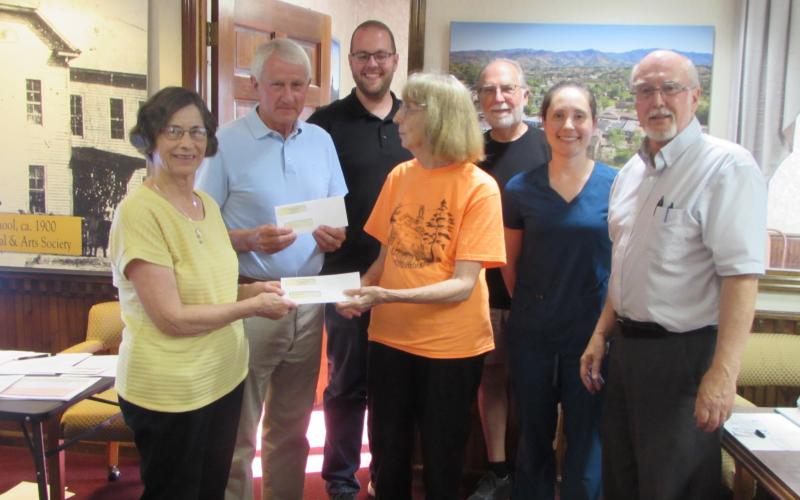 Receiving Town of Hayesville non-profit grant awards Monday night were Sara Smith, Paul Price and Reba Beck. Standing left to right are Smith, Price, Councilman Austin Hedden, Beck, Councilman Joe Slaton, Councilwoman Lauren Tiger and Mayor Harry Baughn.