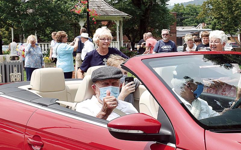 Becky Long • Clay County Progress Kenneth Woodard gives a thumbs up as he continues laps around the town square with son Warren driving and great-grandson Braeden Lee, 12, in the back sea