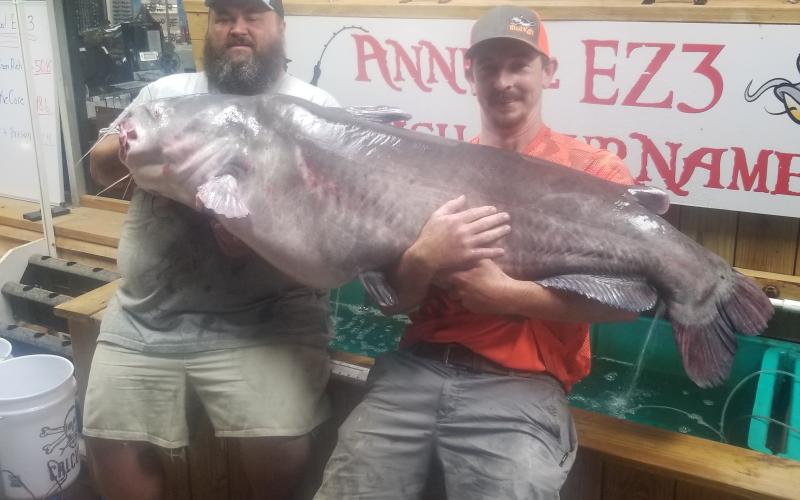Rocky Baker needs help holding up his new state record blue catfish.