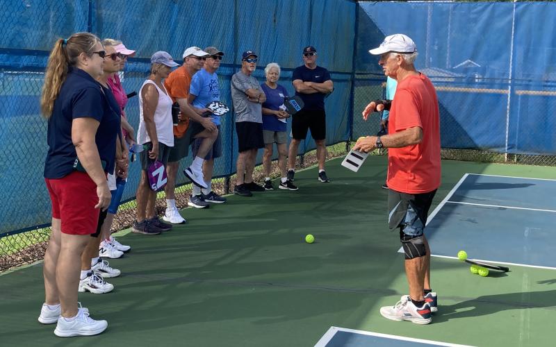 Harry Jarrett leads a group of ten new area pickleball players during an August skill clinic held at the Clay County Sports Complex.