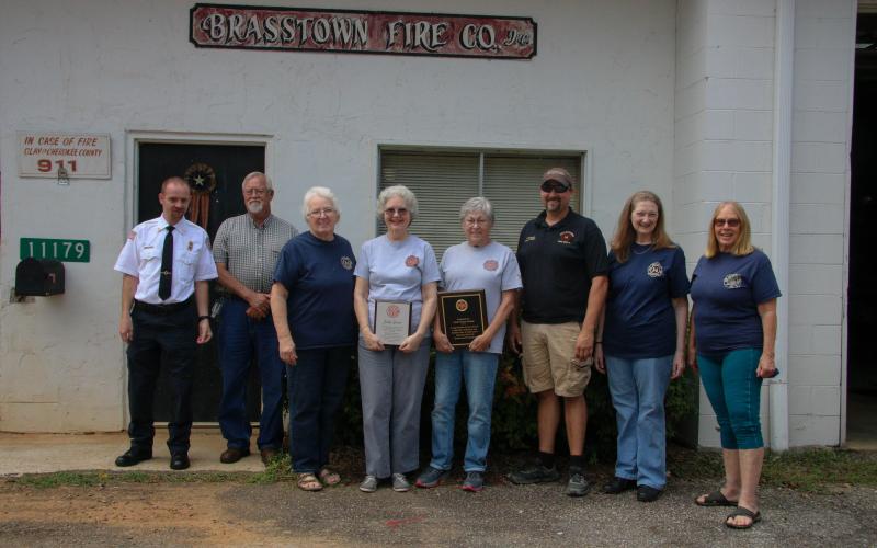 From left, CCFR Asst. Chief Chris Denton; Clay County Commissioner Clay Logan; Brasstown Fire Dept. Officers and Board Members Joyce Portik, Judy Grove, Paulette Tonielli, Tim Noland, Charlotte Bristow and Linda Allen.