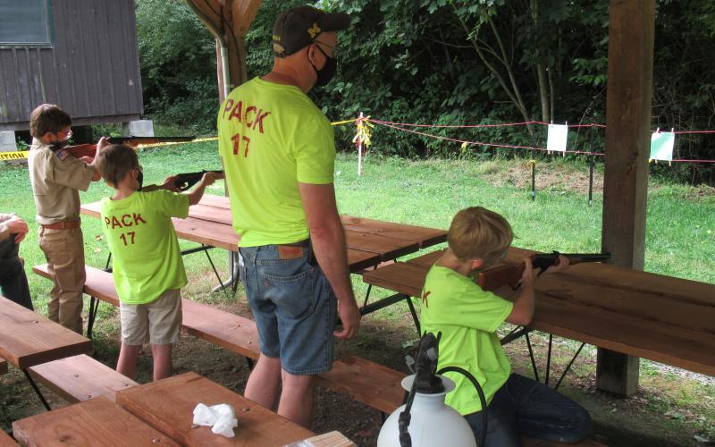a Cub Scout pack takes aim during a BB gun target event.