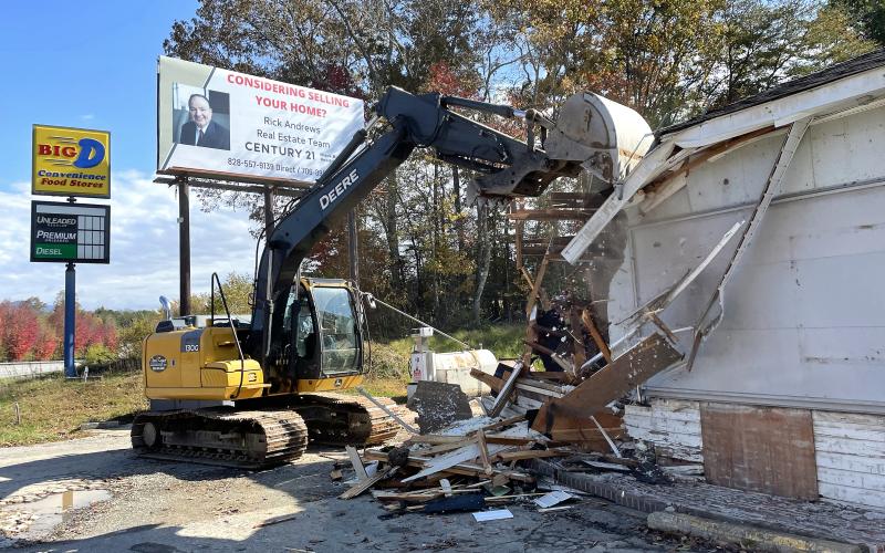 Workers tear down the Bid D Convenience Store at Old Highway 64 on Tuesday in Hayesville.