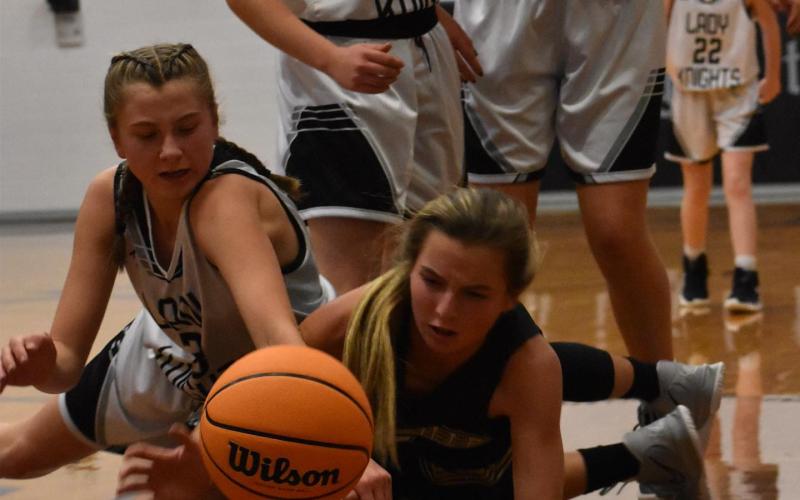 (Kevin Hensley • The Graham Star) Hayesville’s Ava Shook tries to block a Lady Knight from getting the ball while preventing the ball from going out of bounds.