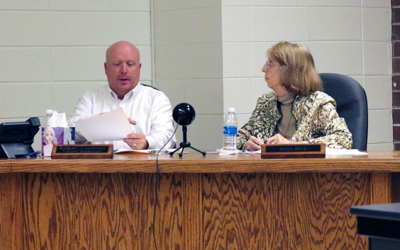 (Jared Putnam * Clay County Progress) Robert Caldwell, Vice-Chairperson of the Clay County Board of Education, and board member Reba Beck talk during the Clay County Board of Education meeting on Monday in Hayesville. The board approved the creation of a "nondiscrimination" resolution similar to ones passed by Cabarrus County Schools and Wayne County Schools earlier this year in response to public fears over Critical Race Theory.