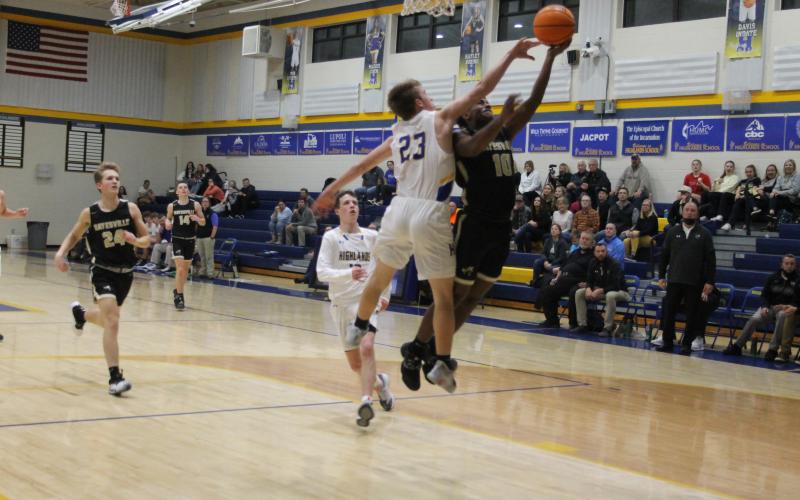 Asher Brown skirts by a defender for a layup against Highlands.