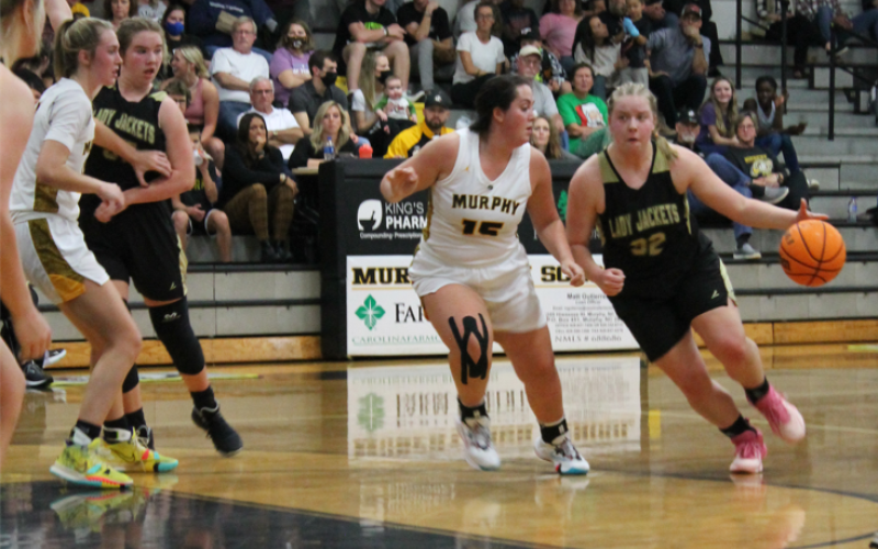 Breanne Cothren drives the ball down court looking for a Lady Jacket basket.