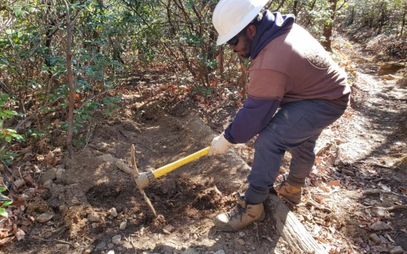 An ACE crew member improving trail conditions along the Mt. Mitchell Trail.