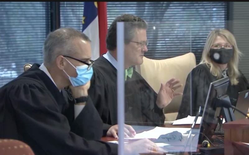 Superior Court Judges, from left, Nathaniel Poovey, Graham Shirley, and Dawn Layton oversee a trial addressing N.C. election maps. (Image from WRAL.com pool video)