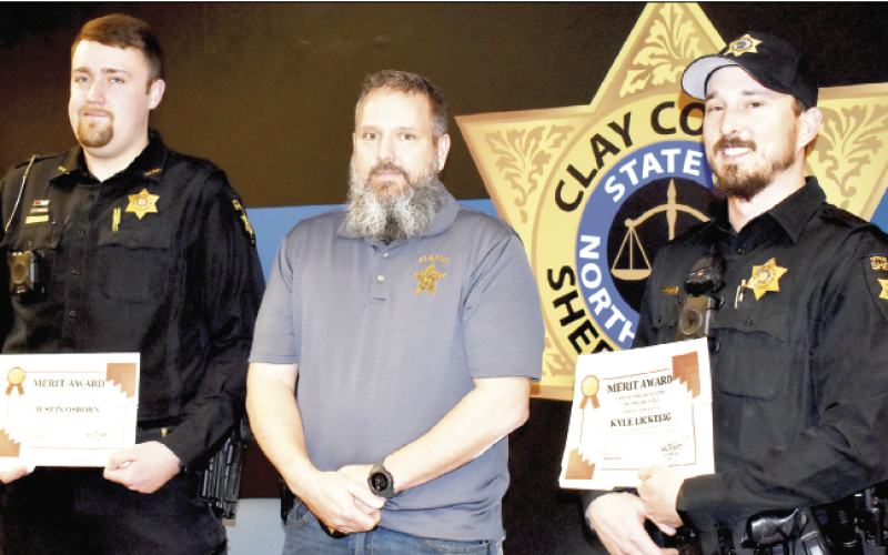 (Becky Long • Clay County Progress) Clay County deputies Justin Osborn, left, and Kyle Lickteig, on right, receive Letters of Commendation from Sheriff Bobby Deese during a brief recognition luncheon on Thursday, Feb. 17. The deputies were distinguished for saving two lives after drug overdose.