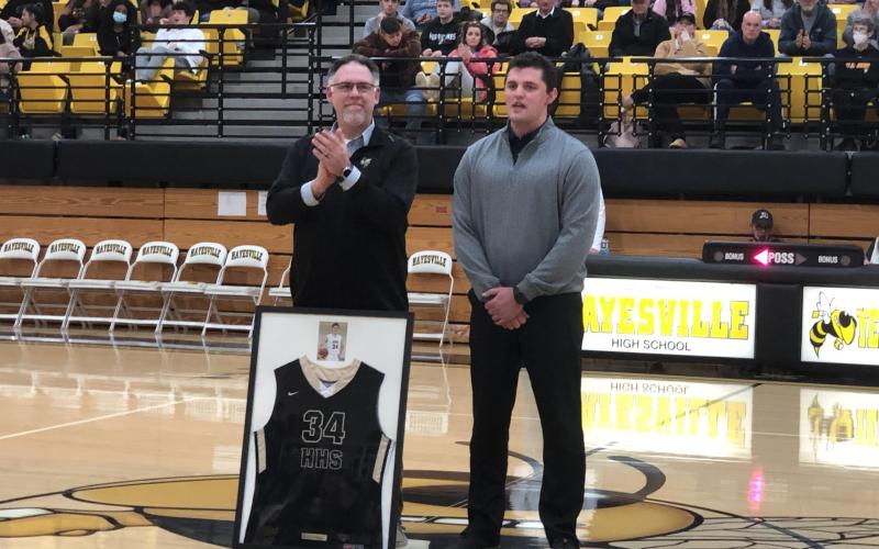(Deby Jo Ferguson • Clay County Progress) On Jan. 28 at the game against Murphy, Hayesville High School Principal, Stacy Overland presented the honors of retiring #34 basketball jersey belonging to Zach Cottrell. The jersey will take it’s rightful place in the showcase along with the other retired jerseys and school trophies.
