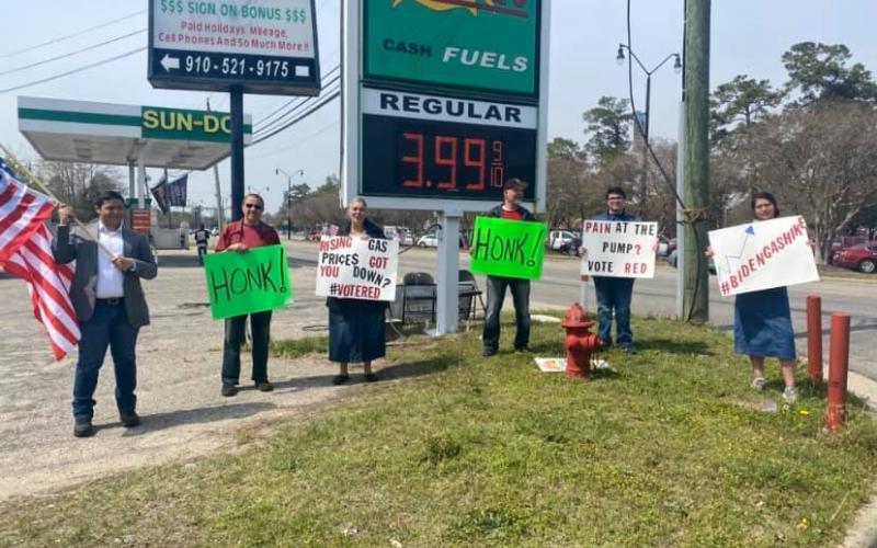 Volunteers waving signs at a gas station voter registration drive in Robeson County, N.C. (Source: RNC)