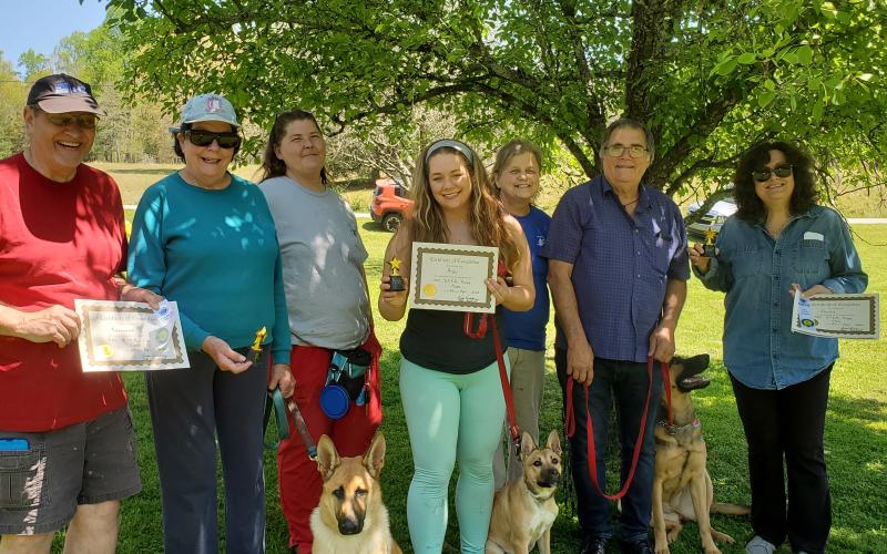Celebrating the AKC S.T.A.R. puppy class graduation are, from left, Jim and Paige Welling and "Roxy;" trainer, Mitzi Shephard, Michelle Poole and "Ash;" trainer, Linda Vanderlaan and Andy and Debbie Accetturo and "Gertie.”