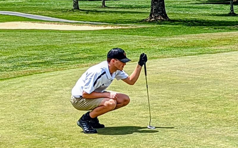 Seth Hedden reads a putt at this year's 1A West Regional Tournament in Newland, N.C.