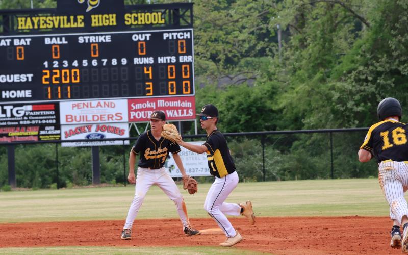 Mike Mauney and Dakota Matheson make a mad dash to second base as Bulldog runner breaks for a steal.