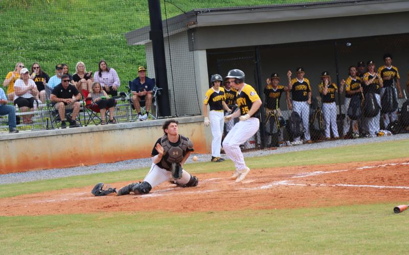Catcher Avery Leatherwood attempts to stop a Bulldog from scoring at home plate.