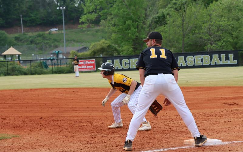 Kyle Lunsford guards first base as a Bulldog runner plans a break for second base.