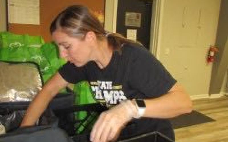 Clay County Senior Center Director Becky Grindstaff spends her Friday mornings packaging food in insulated bags for the day’s recipients.